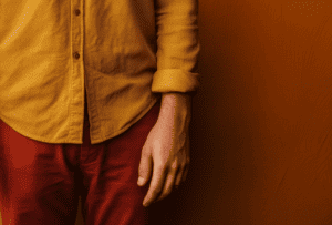 Cross-section of a man's torso with only the left hand visible.
