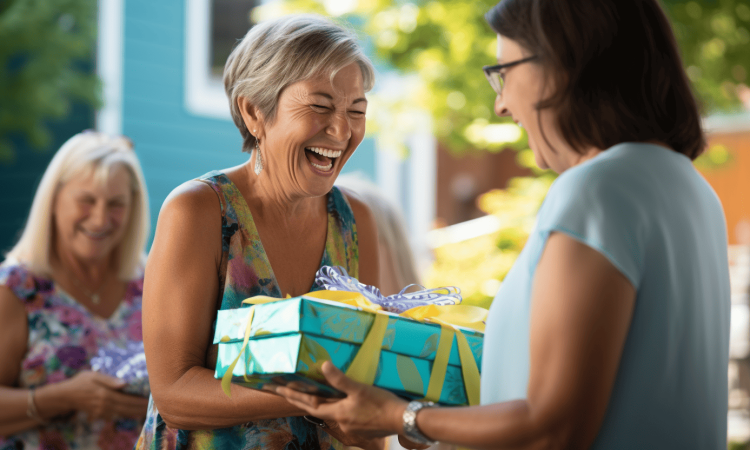 Middle aged woman receiving a gift box with a huge grin and looking thankful